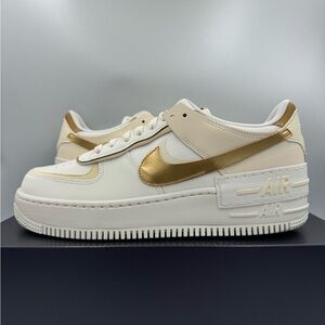 Nike Women's Sneakers in White and Gold